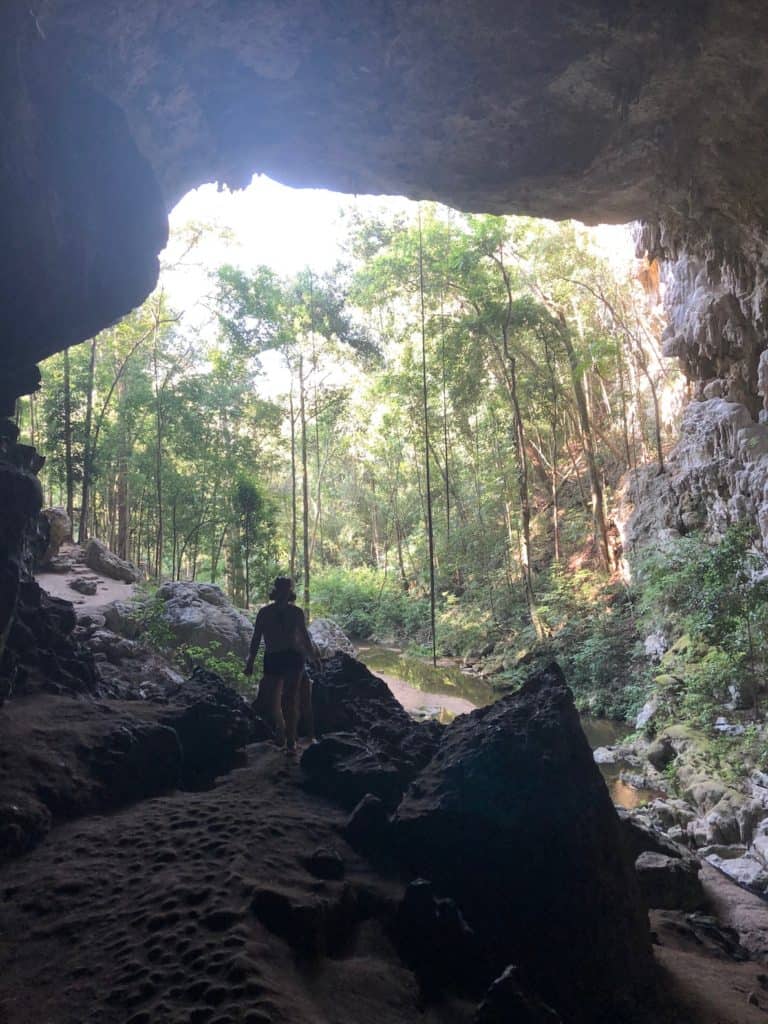 Silhouette of girls standing at entrance of Rio Frio Cave near San Ignacio Belize