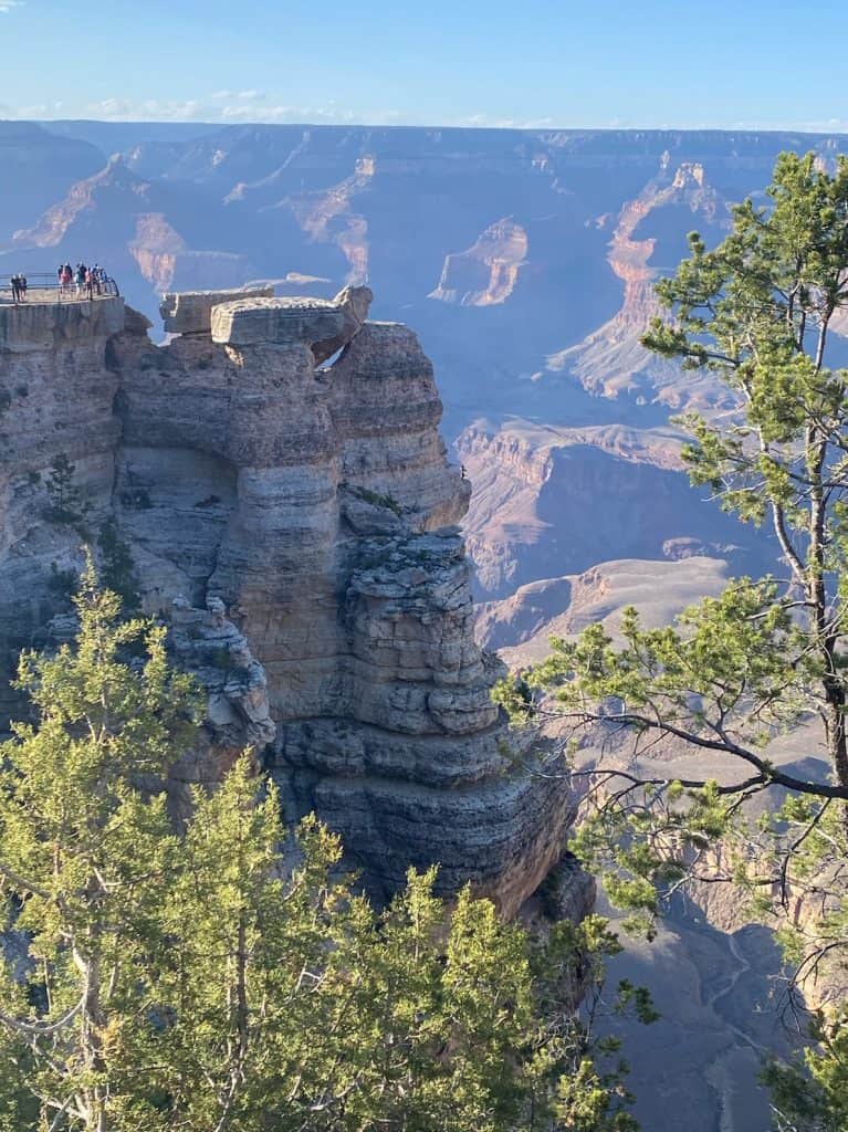 tiny-people-in-distance-on-grand-canyon-ledge-with-views-of-grand-canyon-in-background-mather-point-what-to-do-with-one-day-grand-canyon-national-park-south-rim-northern-arizona