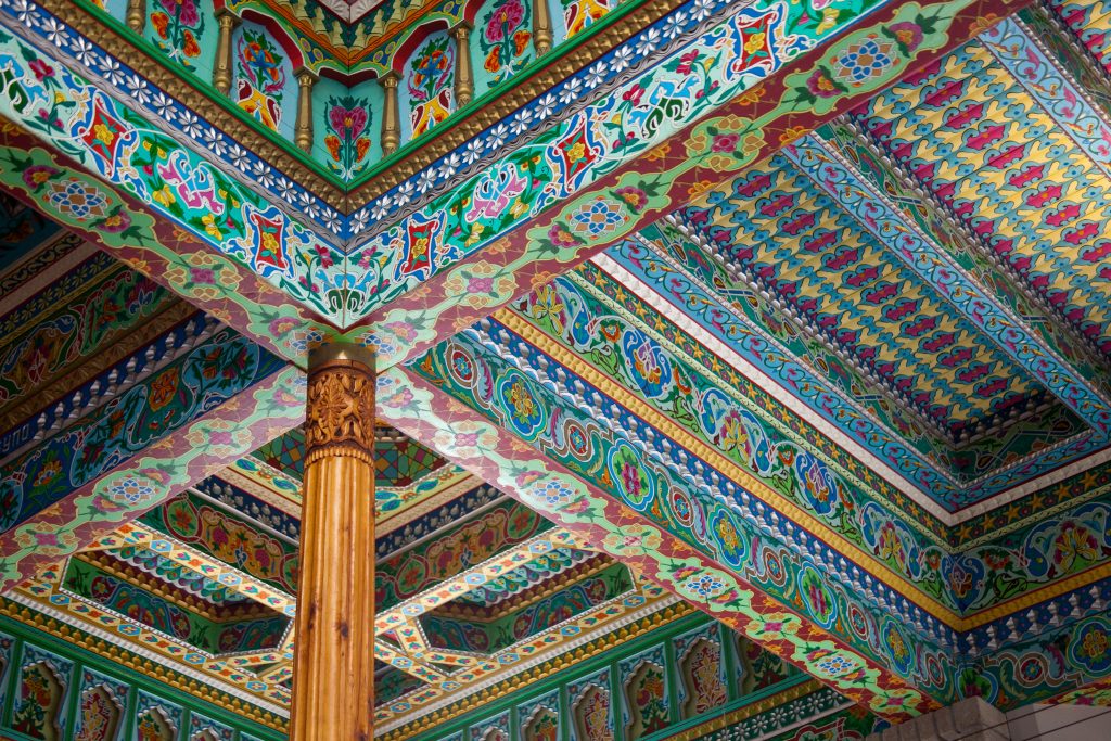 elaborate handmade colorful ceiling tiles covering entirety of teahouse-ceiling with elaborate colors and shapes. Dushanbe Teahouse, Boulder, Colorado.