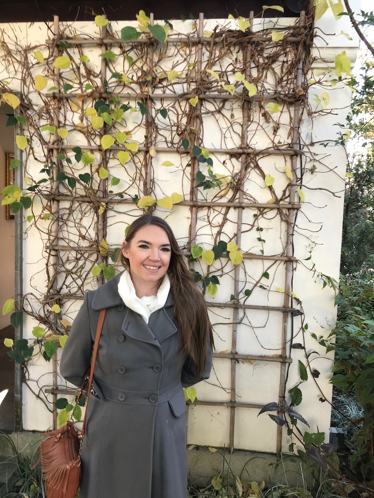 girl smiling in front of vine wall at Lan Su Chinese Gardens - How to spend a weekend in Portland, Oregon
