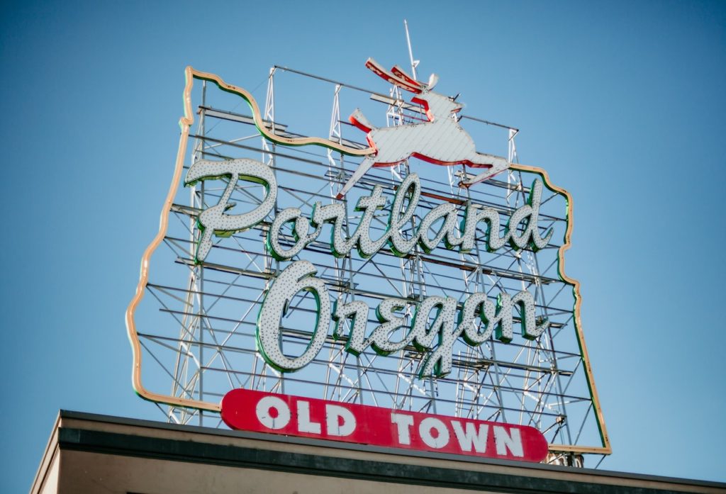 sign with white stag reading "Portland Oregon Old Town" - How to spend a weekend in Portland, Oregon