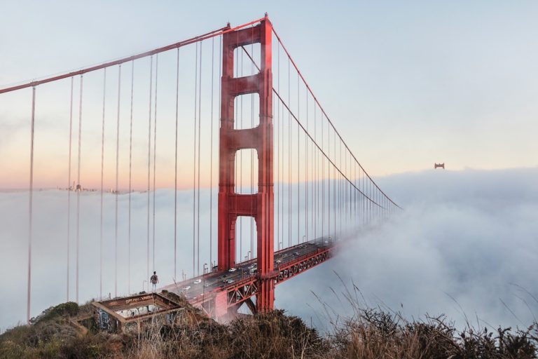 Fog covered golden gate bridge during sunset. Golden Gate Bridge, San Francisco, California.