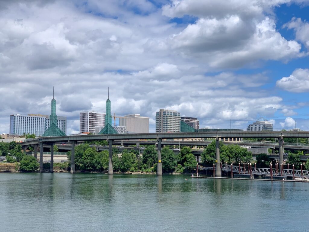 City skyline views and highway bridge over Willamette River in downtown Portland, Oregon.