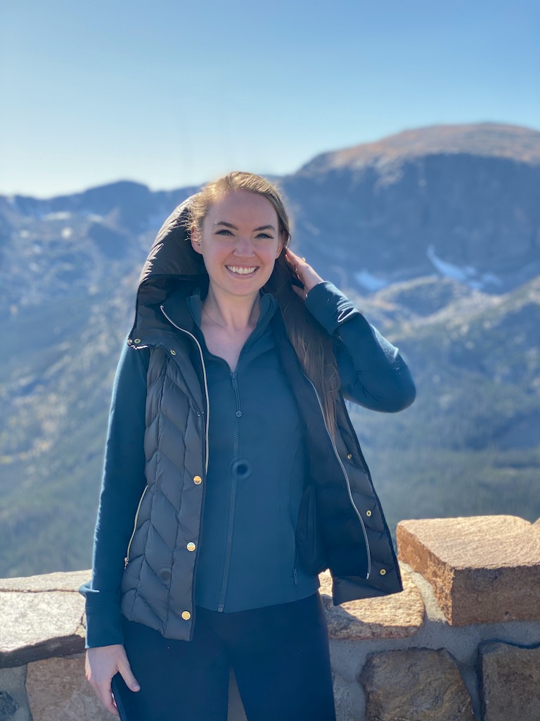 woman smiling at viewpoint on trail ridge road during fall rocky mountain national park colorado