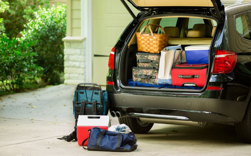 car loaded with suitcases for road trip holiday travel