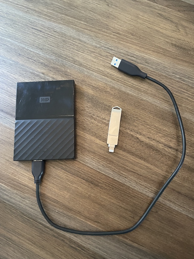 External hard drive and phone-friendly external hard drive on table.