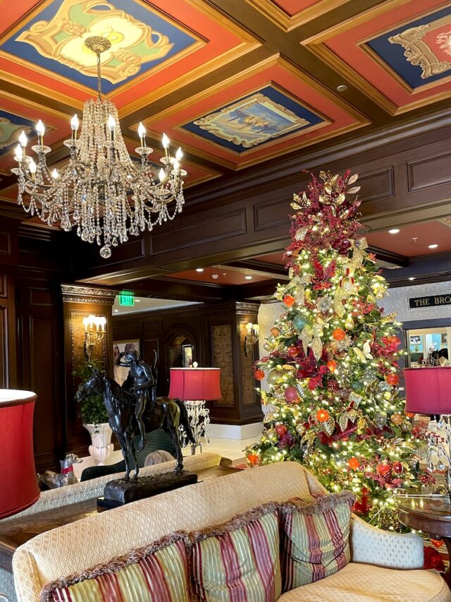 Hotel sitting area with elaborate, expensive decor and furnishings, chandelier, and large Christmas tree. The Broadmoor Hotel, Colorado Springs, Colorado.