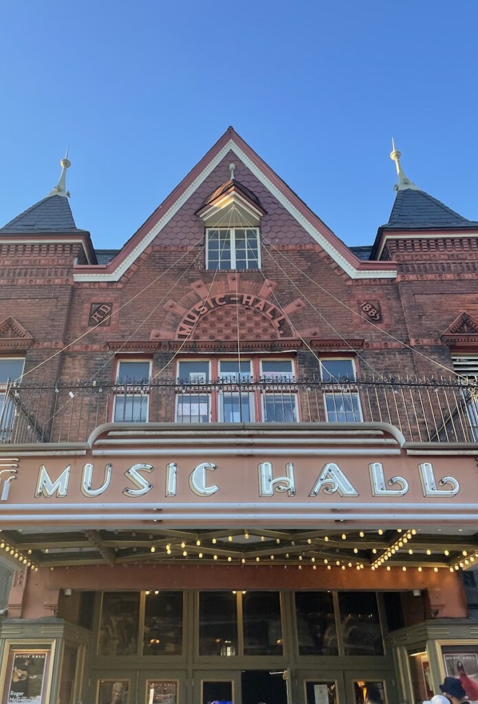 Ornate brick building with old neon sign reading "music hall" on sunny day. Tarrytown Music Hall, Tarrytown, Hudson Valley, Upstate, New York.