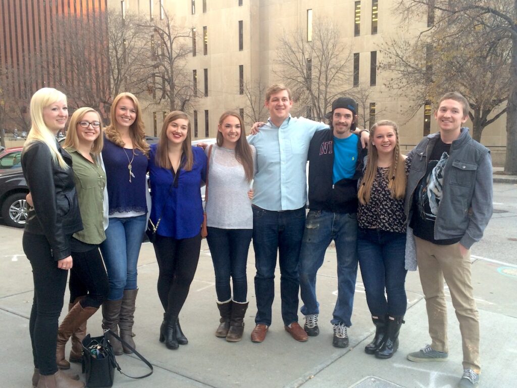 Family smiling at camera in downtown Omaha, Nebraska.