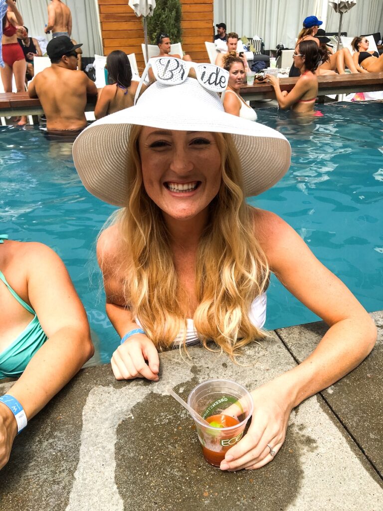 Bride-to-be in pol wearing white hat and "bride" sunglasses during pool party. W Austin, Austin, Texas.