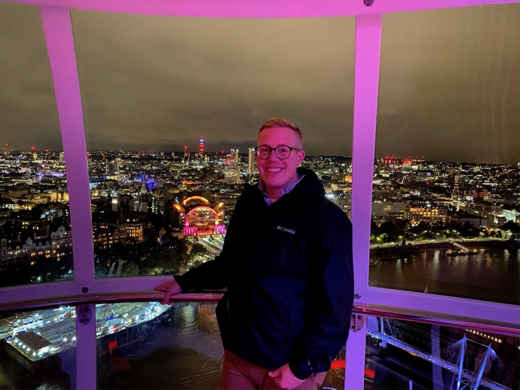 person in pod of london eye at night london england uk