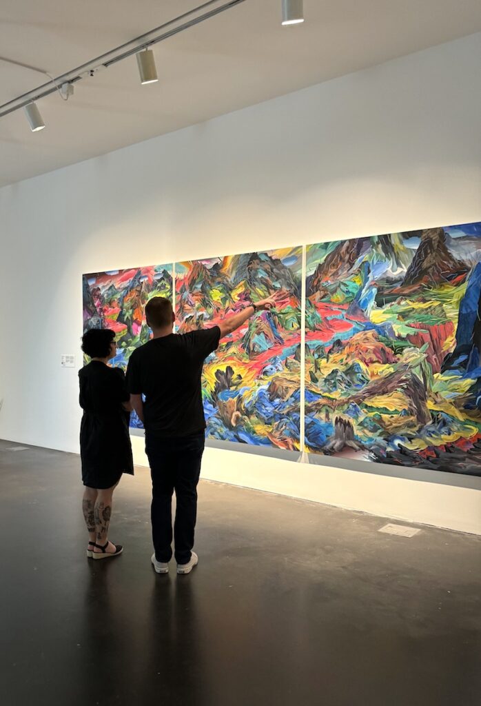 Man and woman looking at large-scale colorful artwork in museum. Museum of Contemporary Art, LoDo, Denver, Colorado.