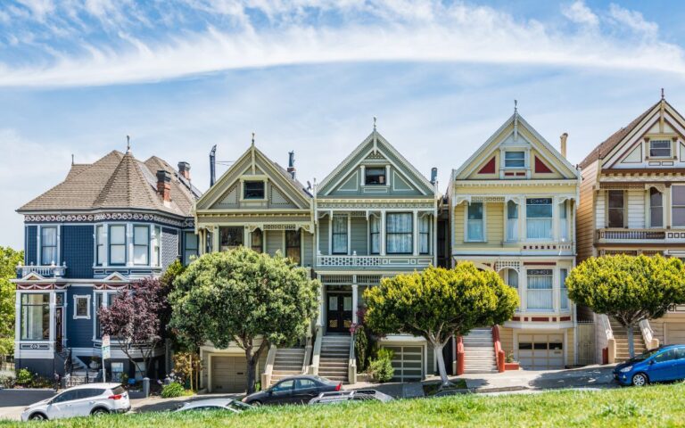 Row of colorful Victorian homes in city on sunny day. Painted Ladies, San Francisco, California.