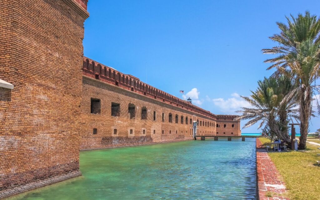 Brick military fort built over turquoise clear waters on sunny winter day. Fort Jefferson, Dry Tortugas National Park, near Key West, Florida.