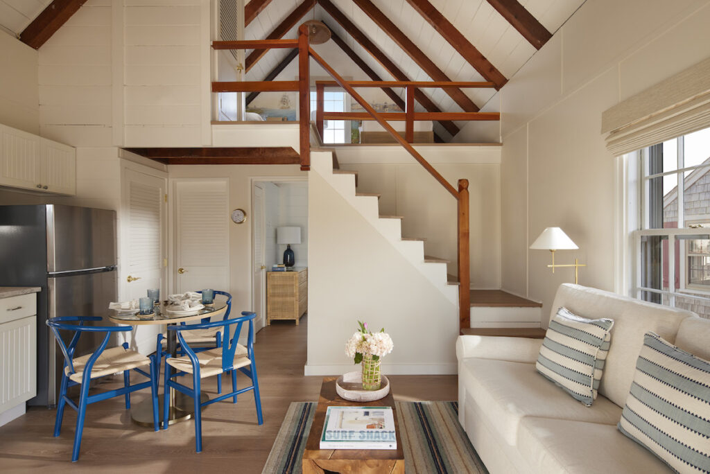 Loft-style guest cottage with kitchen, living area, and bedroom with nautical decor. Cottages at Boat House Basin, Nantucket, Massachusetts.