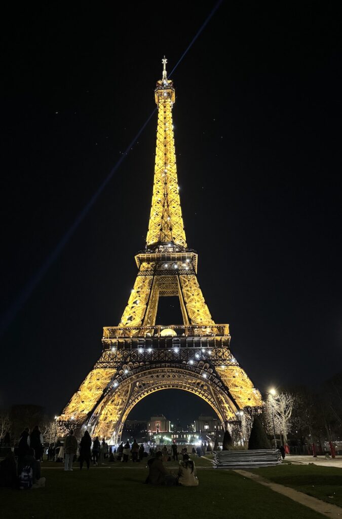 effiel tower lit up at night Paris France