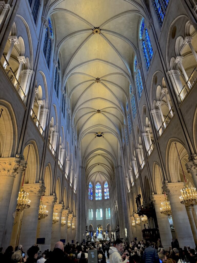 interior of notre dame church with grand archways Paris France