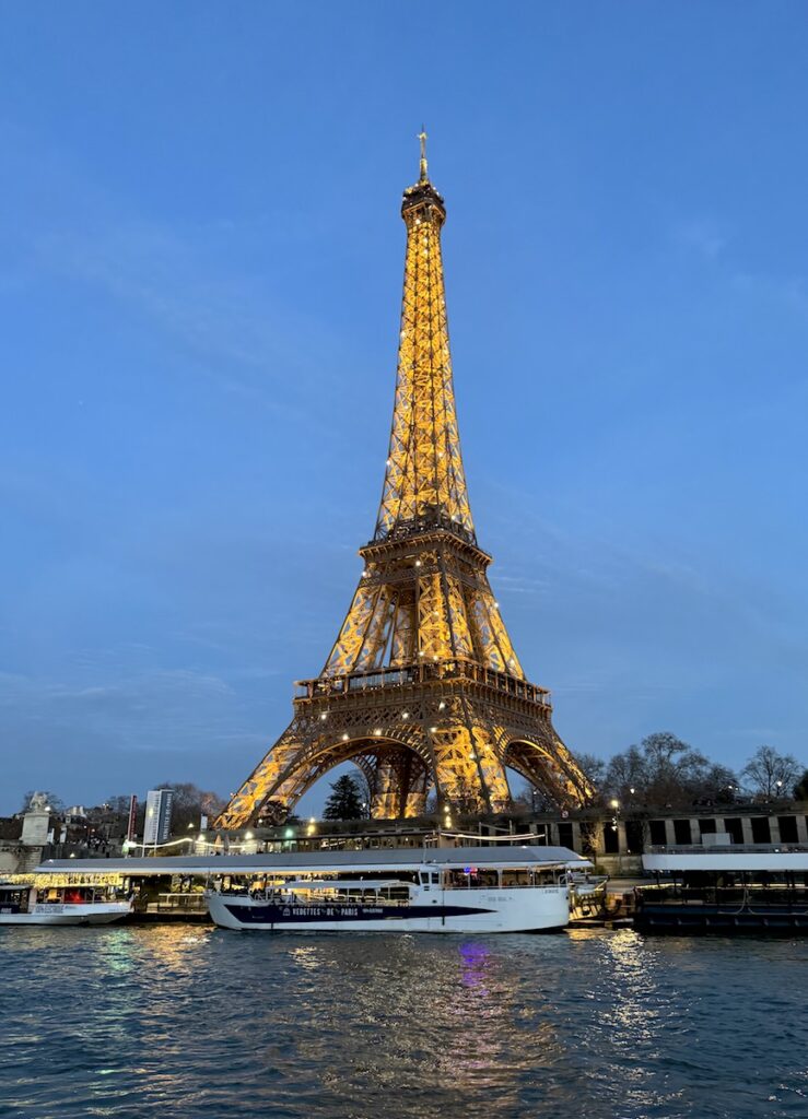 eiffel tower lit up at night sunset happy hour cruise seine river paris france