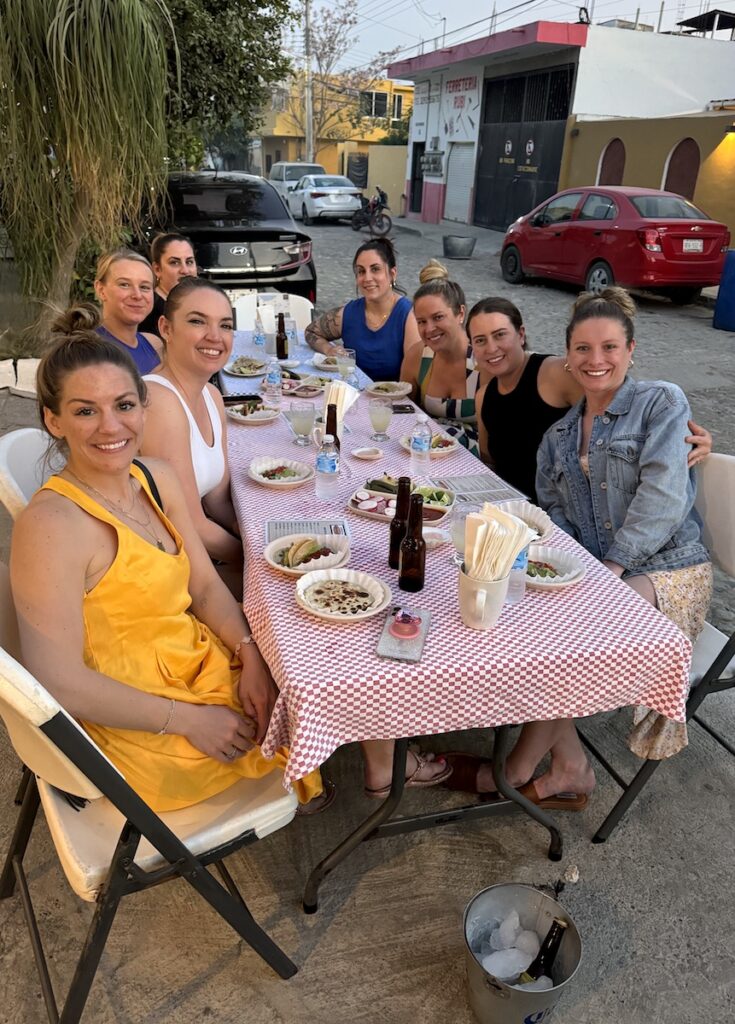 group of girls eating at outdoor restaurant Tacos on the Street La Cruz Mexico