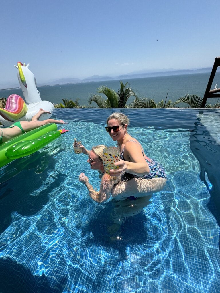 women in pool with margaritas near puerto vallarta and punta mita mexico