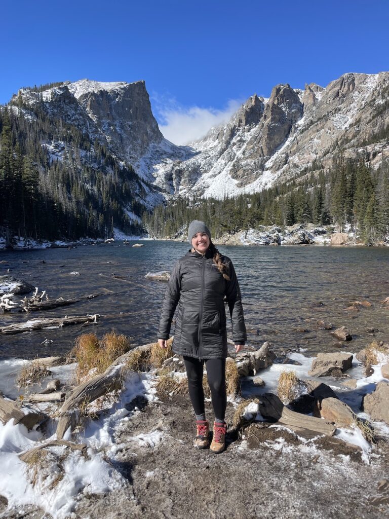 woman hiking dream lake in fall rocky mountain national park colorado