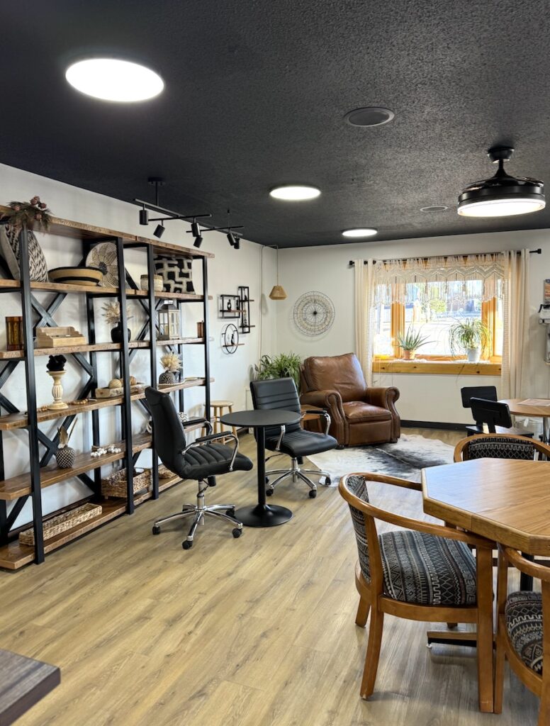 Guest lobby area of boutique hotel with cozy seating areas and bookshelf. Hansen Inn & Cabins, Wall, South Dakota.