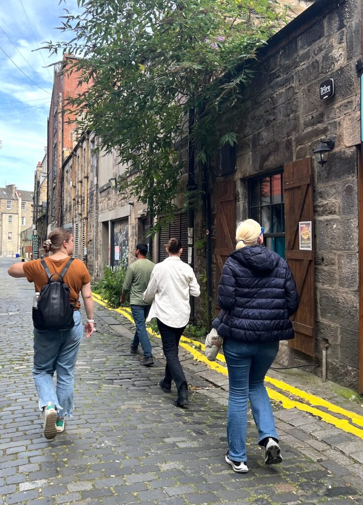 friends walking through alley in Edinburgh Scotland United Kingdom
