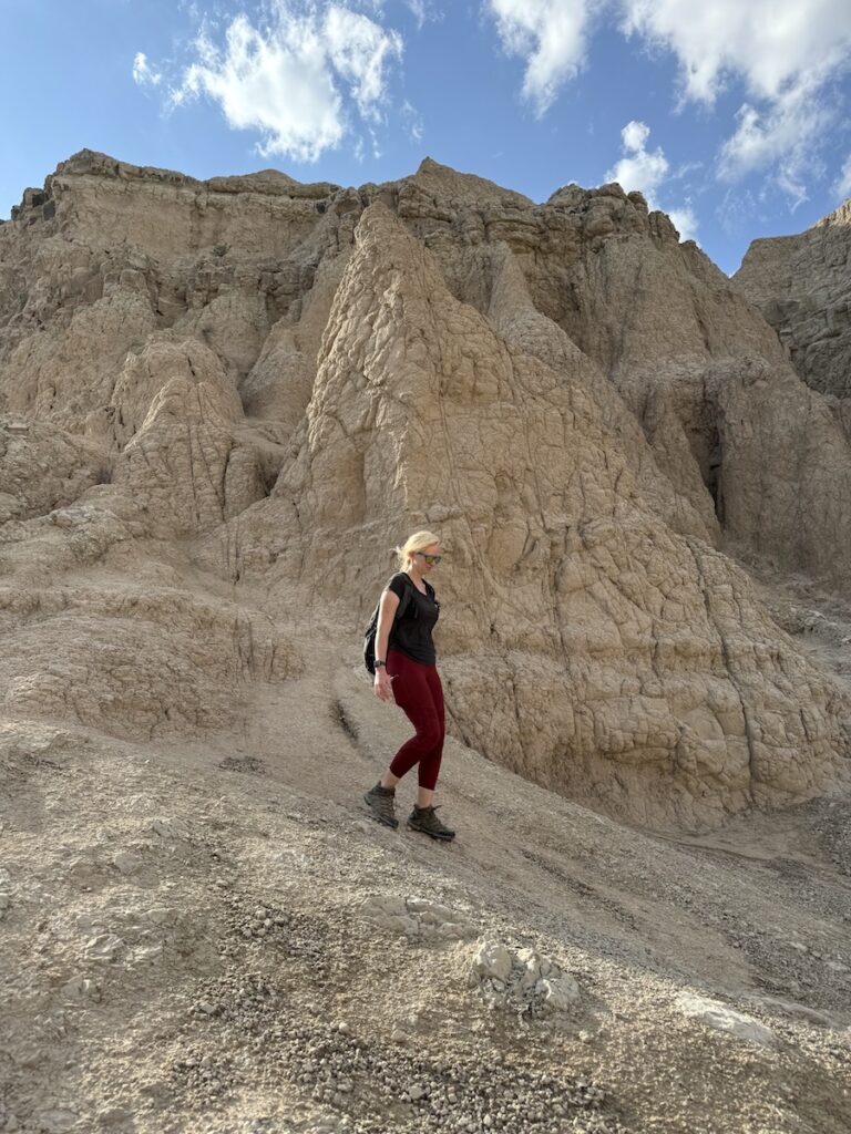 woman hiking hoodoos of notch trail badlands national park south dakota