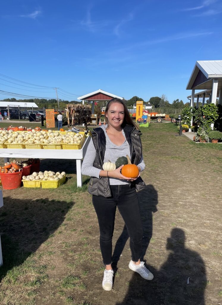 woman selecting pumpkins at hanks pumpkintown southampton water mill new york the hamptons