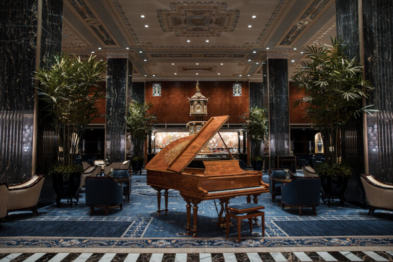 Grand piano in center of elaborately decorated luxury hotel lobby. The Waldorf Astoria, Midtown Manhattan, New York City, New York.