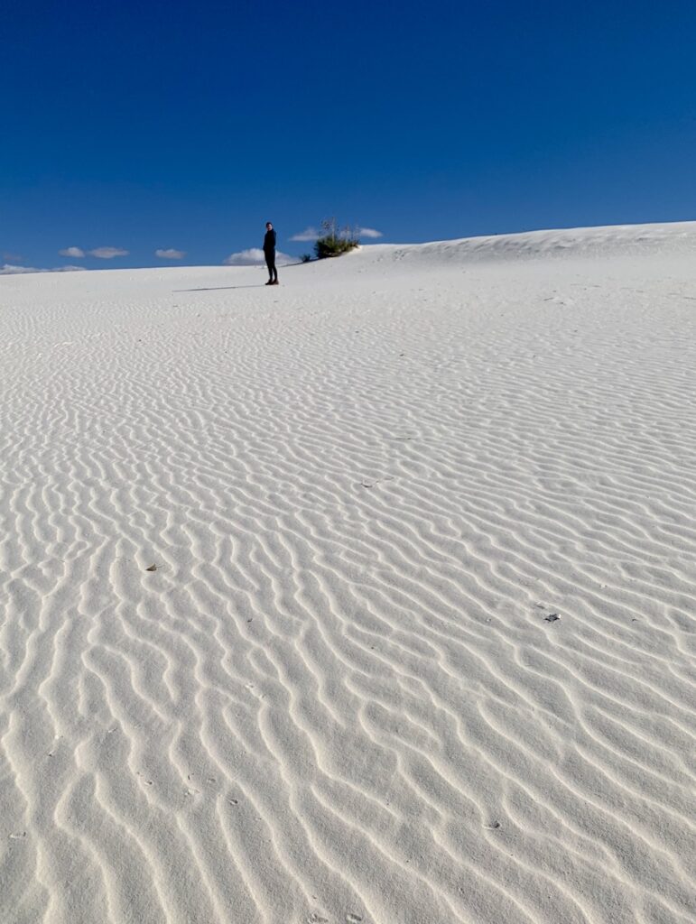 wavy sand woman hiking white sands national park new mexico