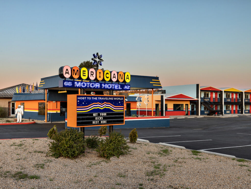 Exterior of colorful retro-style motel with sign reading "Americana Motor Hotel." Americana Motor Hotel, Flagstaff, Arizona.