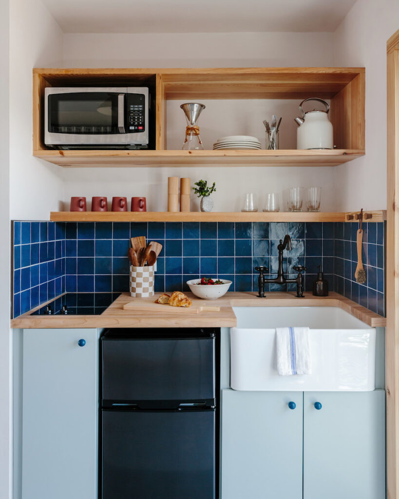 small kitchenette with colorful cabinets and backsplash tiles in luxury renovated motel. Daunt's Albatross, Montauk, New York, The Hamptons
