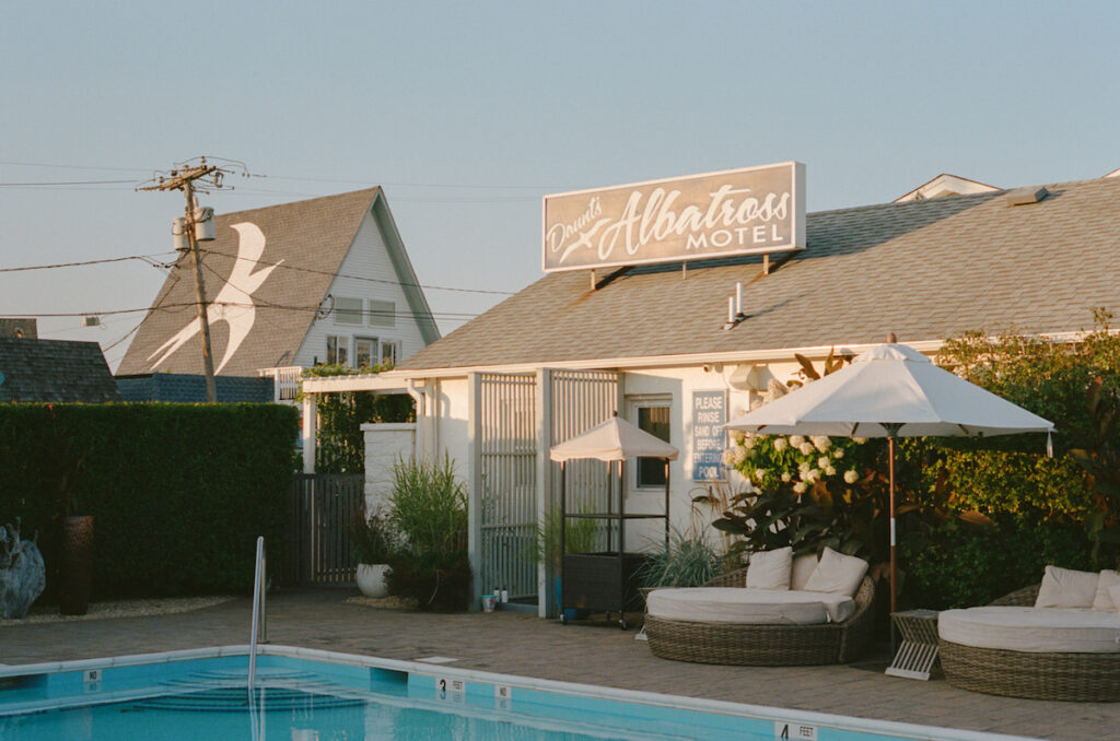Removed motel with outdoor pool, cozy lounge chairs, and large sign reading "Daunt's Albatross Motel" Daunt's Albatross, Montauk, New York, The Hamptons