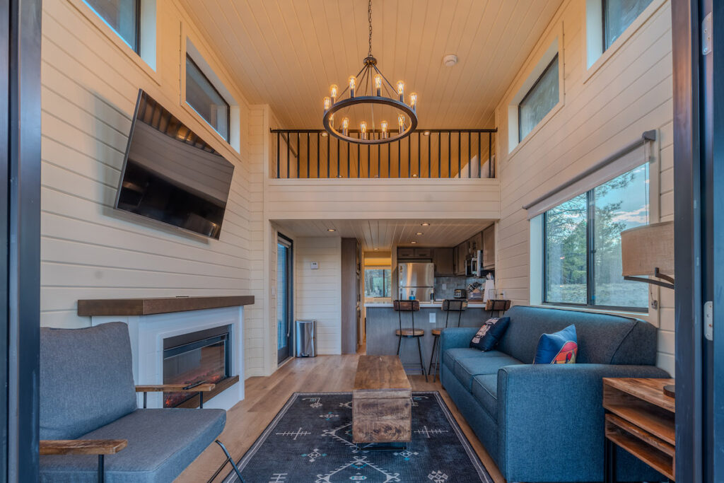 Luxury hotel cabin with living room seating area and small kitchen. Village Camp Flagstaff, Bellemont, Arizona.