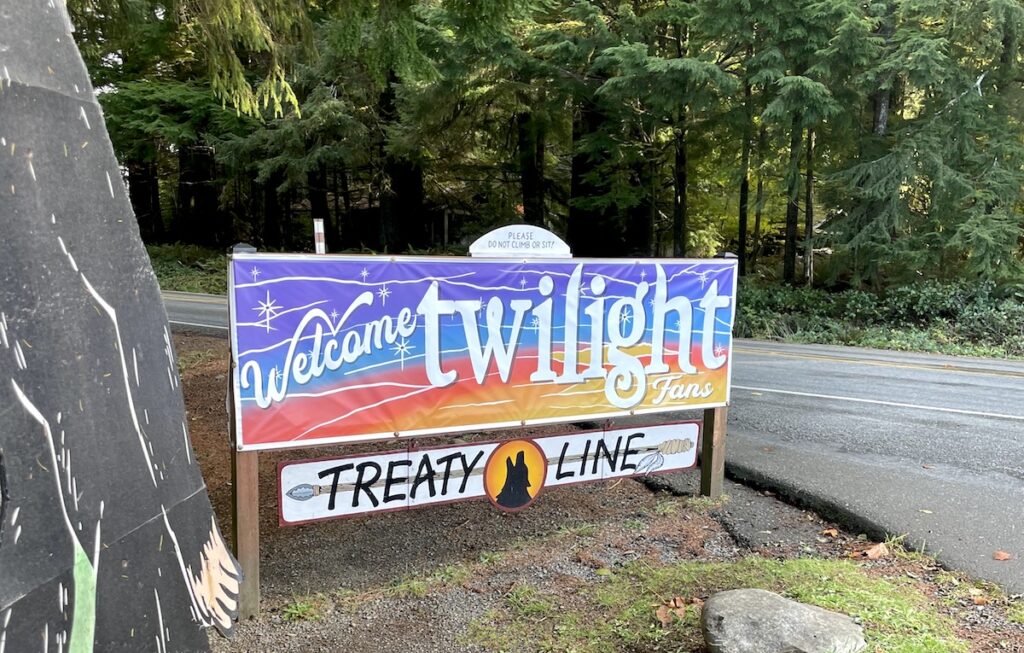 Roadside sign in forested area with sign reading "Welcome Twilight Fans / Treaty Line" La Push, Olympic Peninsula, Washington.