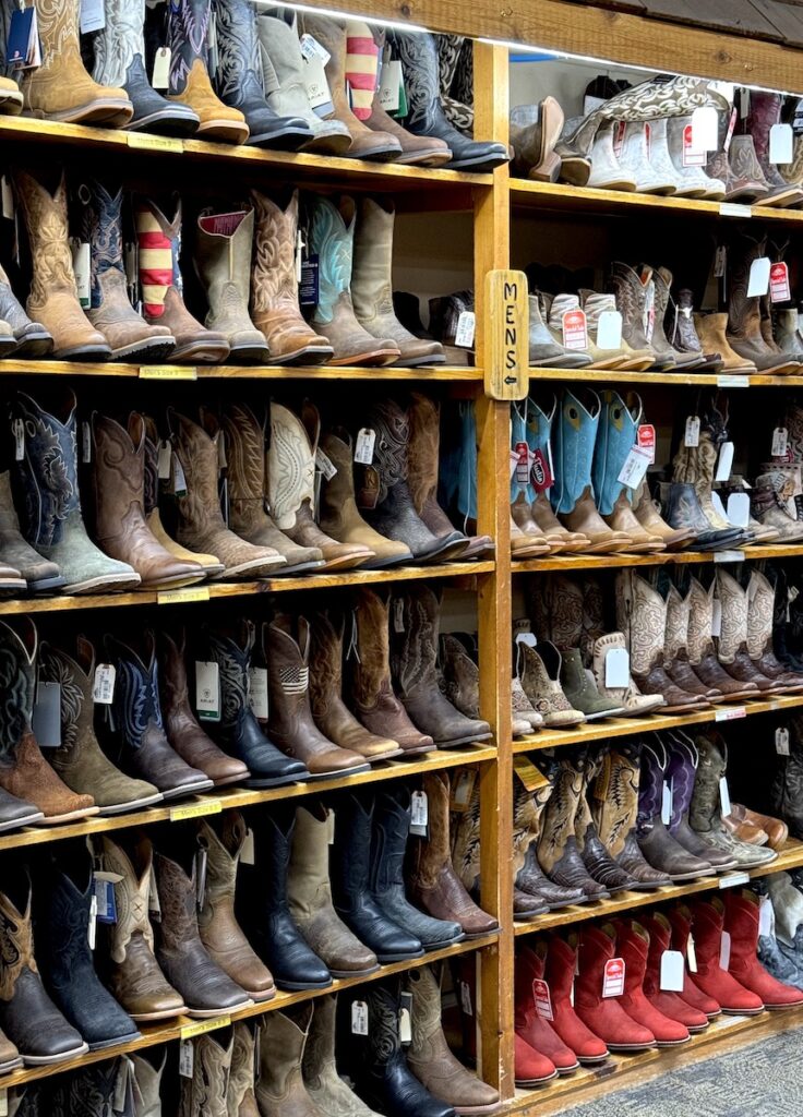 Shelves full of cowboy boots in rustic looking retail shop. FM Light & Sons, Steamboat Springs, Colorado.