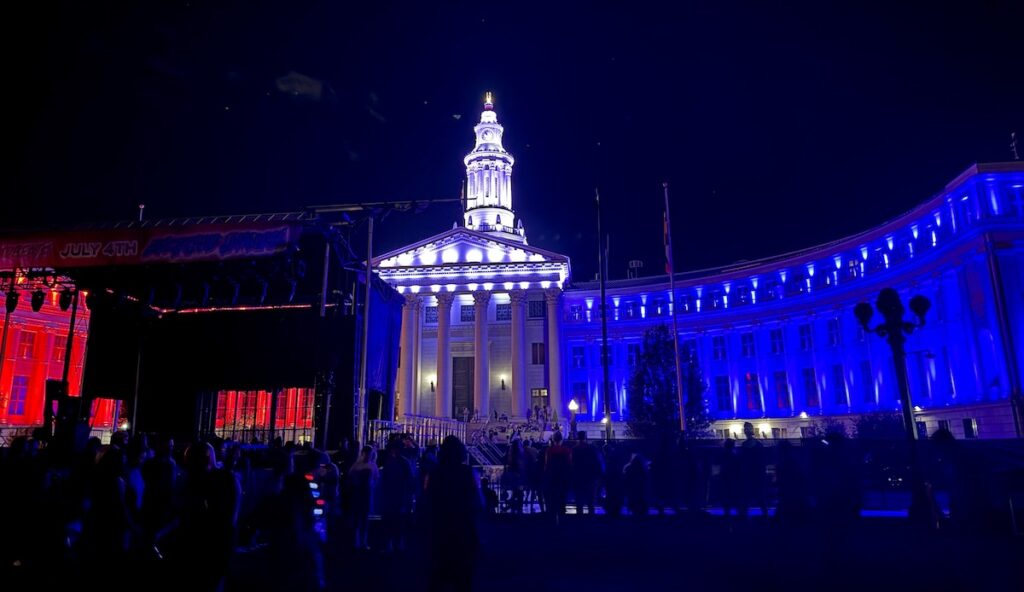 red white and blue lit city and county of denver building indy eve celebration civic center park denver colorado
